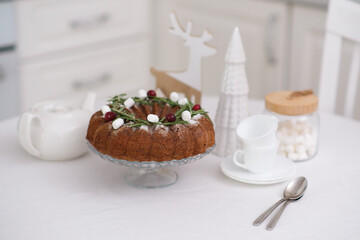 Christmas home interior in white kitchen Christmas chocolate bundt cake with fresh berries and rosemary. Winter baking. christmas trees. High quality photo