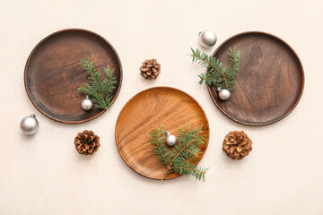 Beautiful table setting with Christmas balls, cones and fir branches on white background