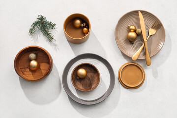 Beautiful table setting with Christmas balls and fir branch on white background