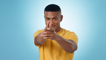 Portrait, finger gun and man aim at target in studio isolated on a blue background mockup space. Face, shooting hand gesture or African person pointing pistol weapon for self defence to kill criminal