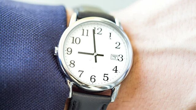 watch close up at 9 AM checking time in the morning 