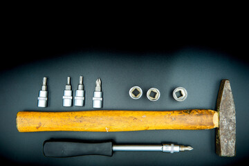 screwdriver hammer and bits isolated on black background