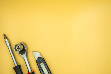 screwdriver torque and knife isolated on cream background - obrazy, fototapety, plakaty
