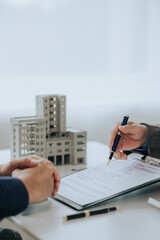Close-up photo of a real estate agent offering a contract to purchase or rent a residence....