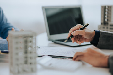 Close-up photo of a real estate agent offering a contract to purchase or rent a residence....