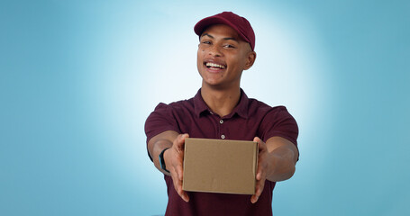 Portrait, happy man and courier with delivery in studio for mock up on blue background in Cape Town. Male model, smile and excited for logistics, shipping or distribution of package, parcel or order