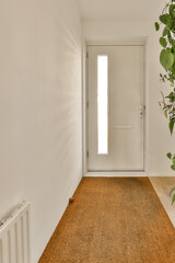an empty room with a plant in the corner and a door to the right, next to it is a white wall