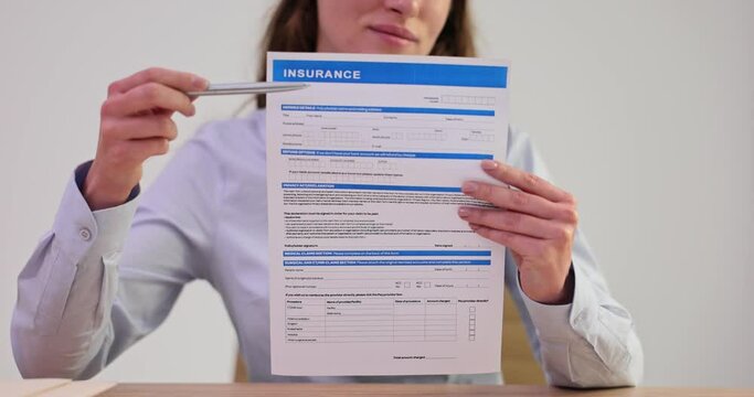 Agent shows offer insurance form for signature closeup