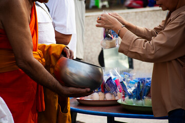 Thai people join rite ritual Tak Bat Devo Buddhism festival and give food offerings to monk in Tak...