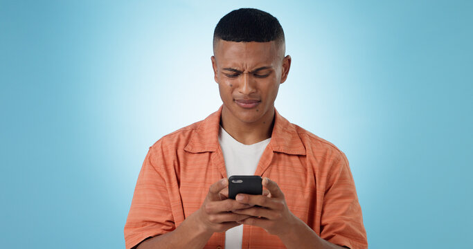 Doubt, confused and man with cellphone, typing and connection with digital app on blue background. Person, guy and model with smartphone, mobile user or reaction with expression, error 404 or contact