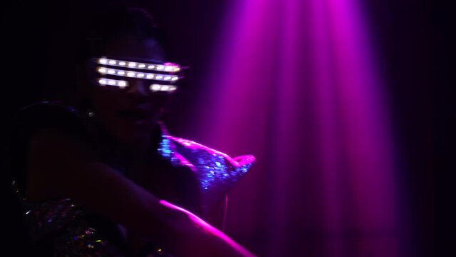 asian dancer in light fantasy costume dancing in night club