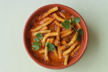 Shev bhaji or sev bhaji, a unique curry recipe made with the combination of spicy gathiya or fried besan noodles and curry from khandeshi kala masala, Can be served with both chapatis or Bhakris
