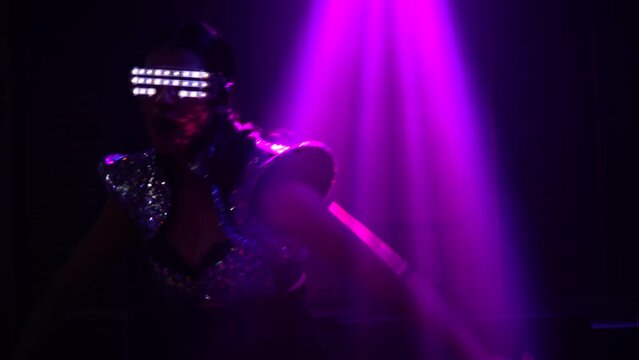 asian dancer in light fantasy costume dancing in night club