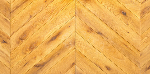 Tightly laid wooden parquet in a herringbone shape with a clear grain pattern.