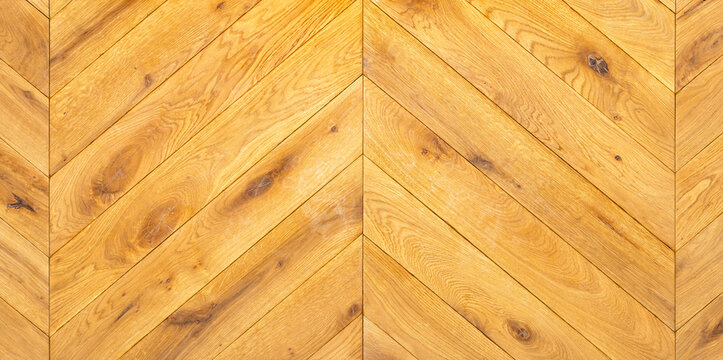 Tightly laid wooden parquet in a herringbone shape with a clear grain pattern.