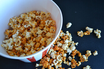 Striped box with popcorn on red background