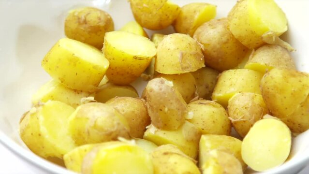 Potatoes rotating in a white bowl. HD image of boiled potato. Vegetarian and plant based vegetable foods. Shallow depth of field food images.