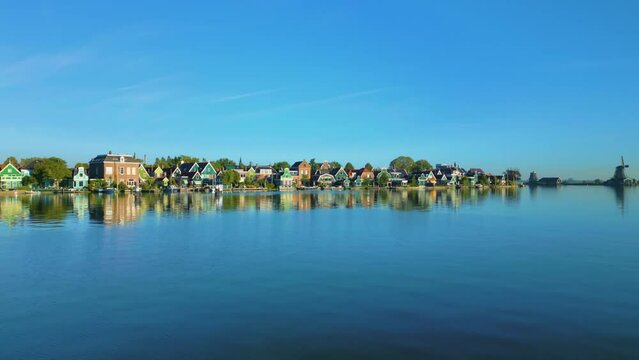 Old traditional wooden houses along the river at the Zaanse Schans, Koog aan de Zaan, Netherlands.