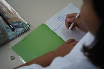Almaty, Kazakhstan - 09.06.2023 : Schoolchildren write a dictation about autumn in class.