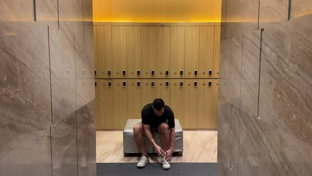 Wealthy Asian Millennial Man Undressing in Luxurious Changing Room