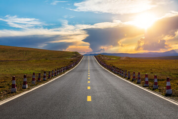 Straight highway road and mountain with sky clouds natural landscape at sunset