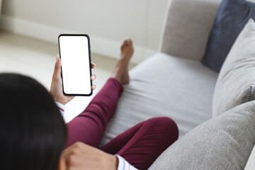 Happy biracial woman having smartphone video call with copy space at home