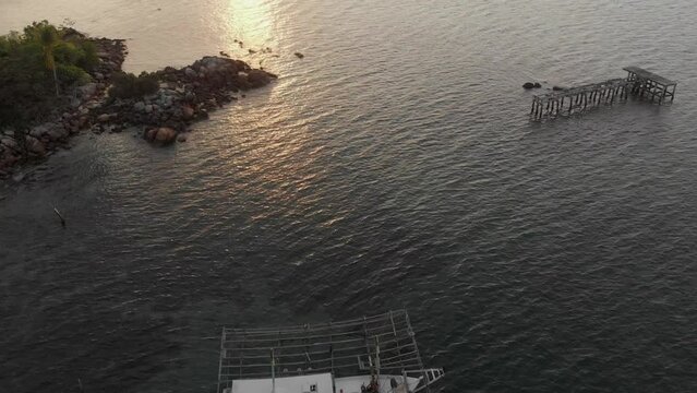 Reveal shot of fishing boats docked near Tanjung binga at Belitung island, aerial