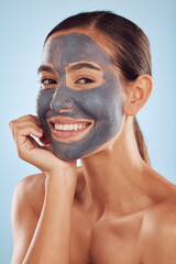 Woman facial portrait and charcoal mask for beauty, skincare and natural cosmetics cleaning product on studio, blue background. Happy person or model in face collagen and mud skin care in dermatology
