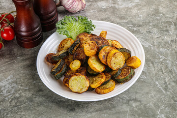 Roasted young zucchini in the plate