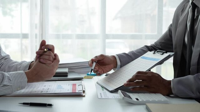 Asian male financial officer or accountant checking investment results Financial budget analysis Planning to summarize results and report to the meeting Audit concept and investment results.