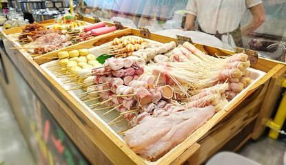 Various Meatballs Skewers Display, Meat skewers, Fresh ingredients Skewers, Meatballs and sausage Thai street food for Shabu, grilled, steamed in the market.