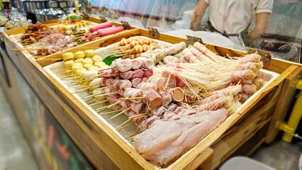 Various Meatballs Skewers Display, Meat skewers, Fresh ingredients Skewers, Meatballs and sausage Thai street food for Shabu, grilled, steamed in the market.