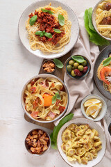 Assortment of Italian pasta dishes on light bachground. Traditional food concept.