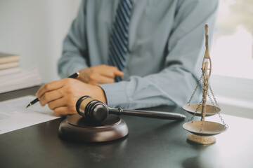 Business and lawyers discussing contract papers with brass scale on desk in office. Law, legal...