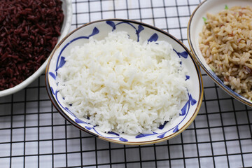 Cooked rice in bowls on cooling rack
