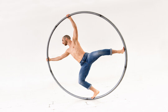 Man performing trick on cyr wheel