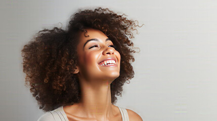 Happy black skinned woman with curly hair enjoys the moment. Isolated on a White Background