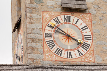 The recently restored clock painted outside the bell tower of the church of the town of Albions in Italy.
