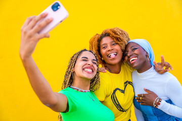 Friends grimacing while taking a selfie together