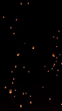 Tourist floating sky lanterns in Loy Krathong festival , Chiang Mai ,Thailand. Vertical video