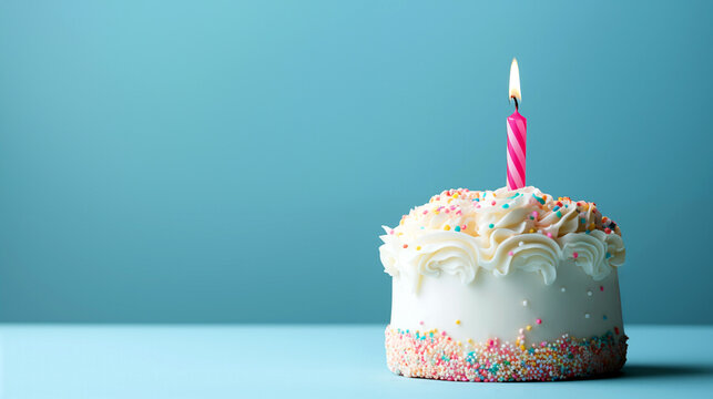 Birthday cake with burning candle on blue background. Copy space for text. High quality photo