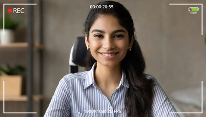 Young indian woman online teacher, counselor, remote tutor or job applicant speaking looking at web cam giving online training, virtual class lesson, video call interview. Webcam view - obrazy, fototapety, plakaty