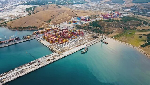 Intermodal freight container yard terminal in sea international port with stacks of cargo containers, export import of global international trade. Aerial view