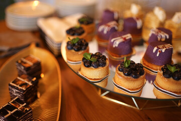 Sweet cakes with filling laid out on a glass stand.