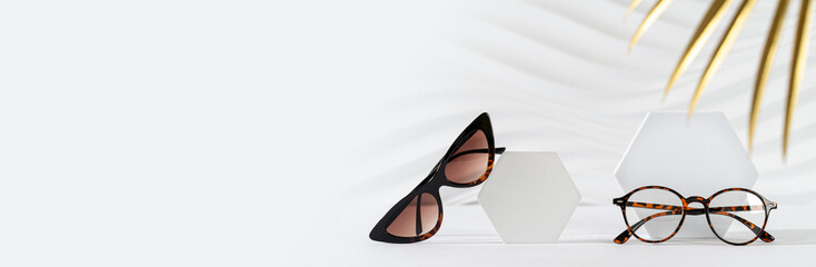 Sunglasses and glasses sale concept. Trendy cat eye frame sunglasses and spectacles on white...