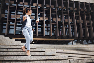 Business woman, city stairs and outdoor with work commute, drinking coffee and worker walking. Urban town, female lawyer with phone on steps during travel and professional in morning with employee