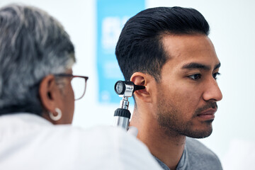 Ear check, man and ENT doctor with patient consultation for hearing and wellness at hospital. Senior, employee and otoscope test of physician with healthcare work and consulting exam with expert - obrazy, fototapety, plakaty