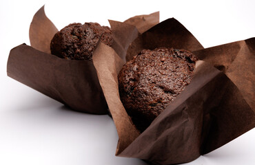 Two chocolate muffins on a white background . Muffin with chocolate chips.