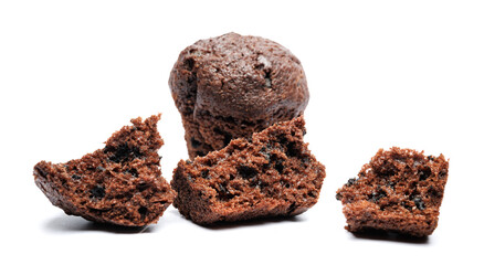 Whole and broken into pieces chocolate muffin isolated on a white background. Chocolate chip muffin.
