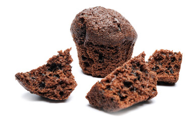 Whole and broken into pieces chocolate muffin isolated on a white background. Chocolate chip muffin.